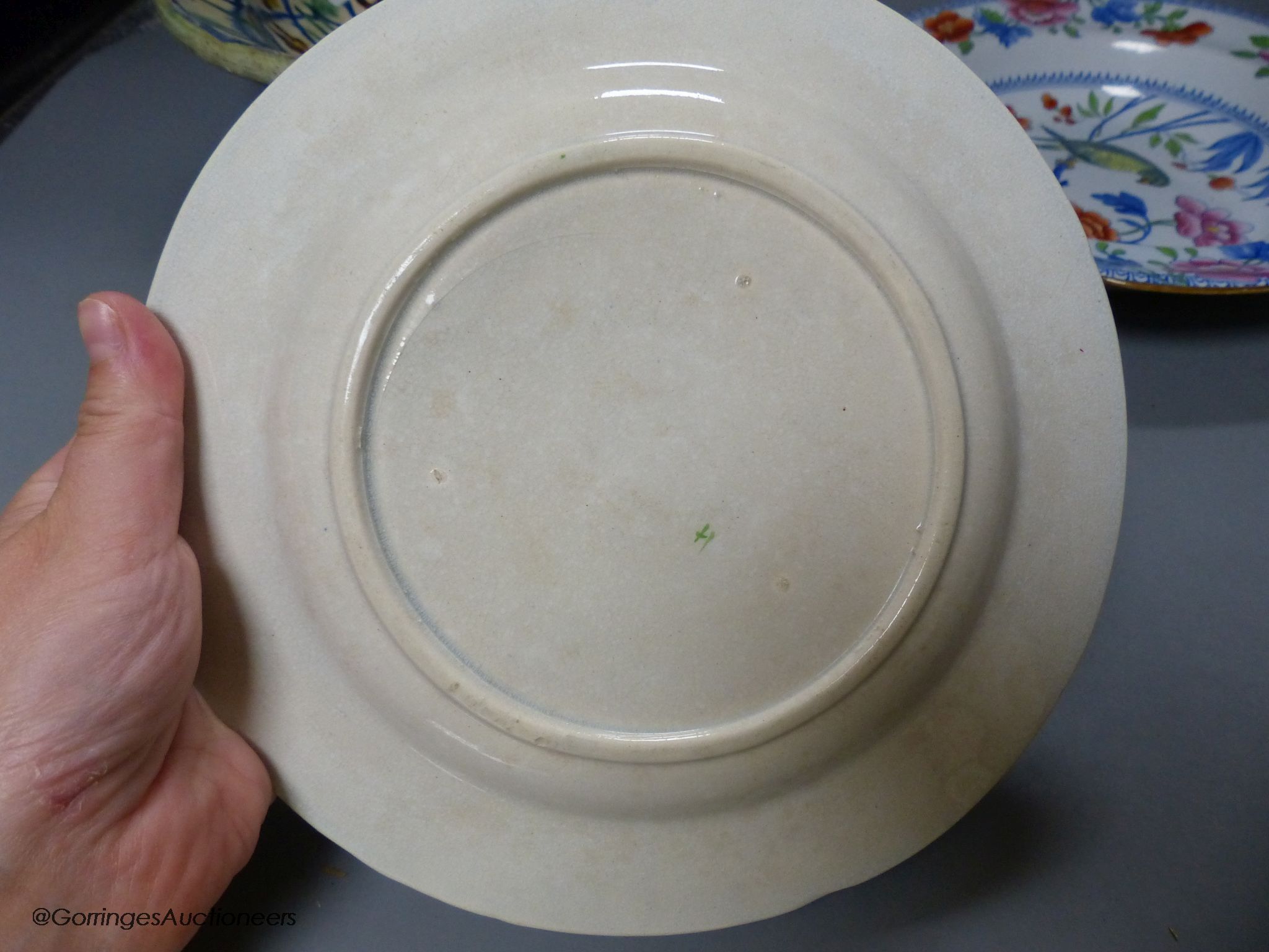 A Moroccan terracotta dish, an Ironstone dish, a green and white leaf dish, largest 30cm